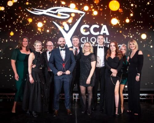 Colleagues from Content Guru and Together standing on a stage at the CCA Global Excellence Awards